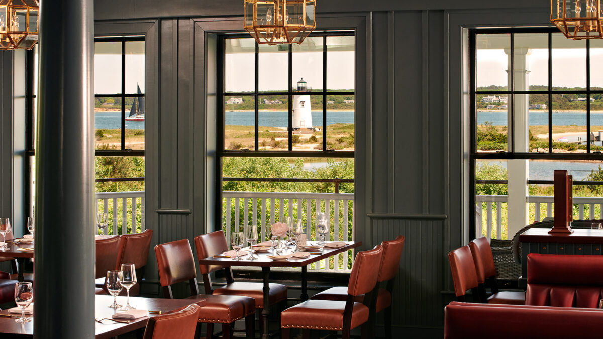 View to the ocean and lighthouse from inside Bettini Restaurant at the Harbor View Hotel on Martha's Vineyard.