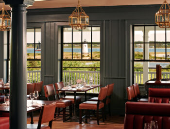 View to the ocean and lighthouse from inside Bettini Restaurant at the Harbor View Hotel on Martha's Vineyard.