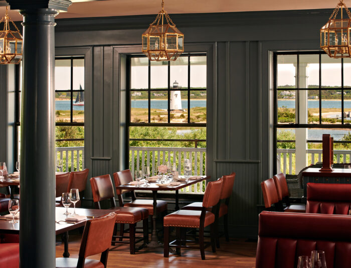 View to the ocean and lighthouse from inside Bettini Restaurant at the Harbor View Hotel on Martha's Vineyard.