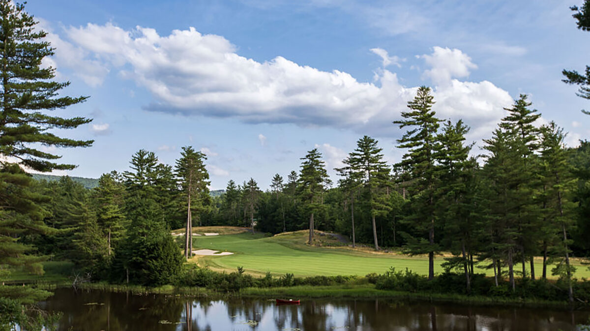 Looking over the water to the fairway of a golf hole at Lake Winnipesaukee Golf Club.
