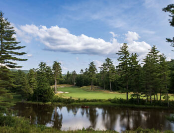 Looking over the water to the fairway of a golf hole at Lake Winnipesaukee Golf Club.