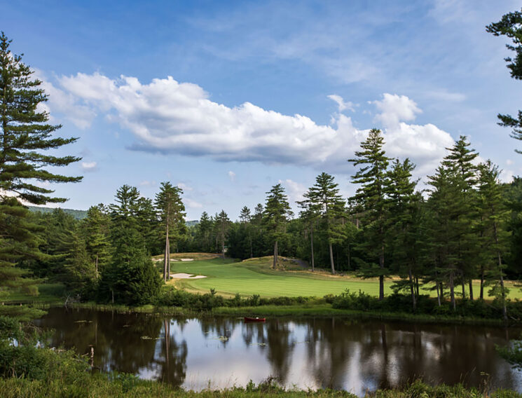Looking over the water to the fairway of a golf hole at Lake Winnipesaukee Golf Club.