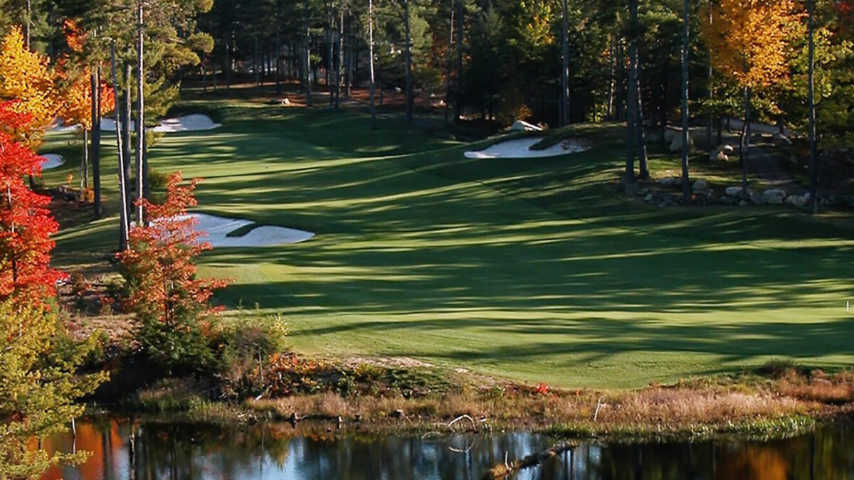 Looking over the water to the fairway of a golf hole at Lake Winnipesaukee Golf Club.