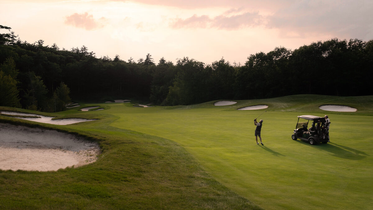 Male golfer taking a swing on a fairway at Lake Winnipesaukee Golf Club.